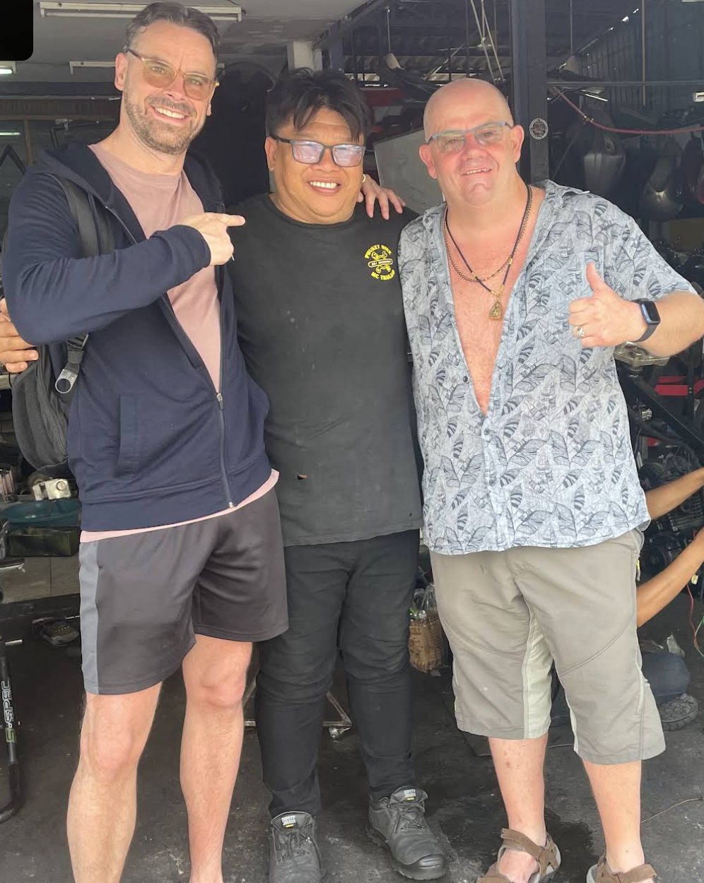 Boy (center) with riders at the Boy Motobike workshop in Chalong, Phuket